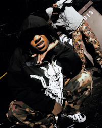 the man is wearing a black hoodie