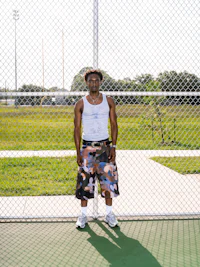 a man standing on a tennis court with a tennis racket